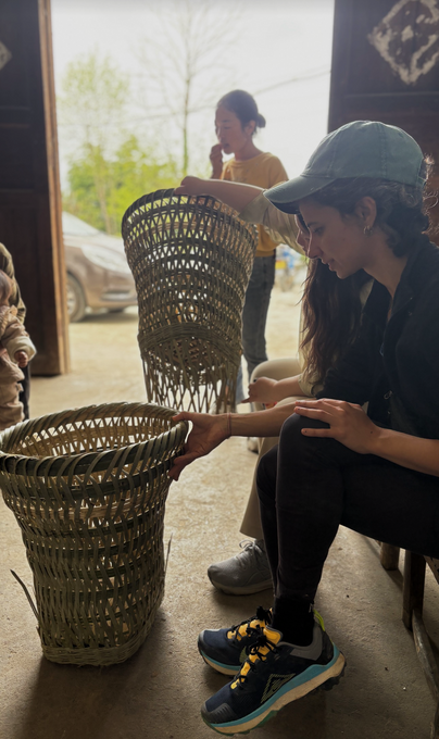A guest with the handwoven bamboo baskets used for picking