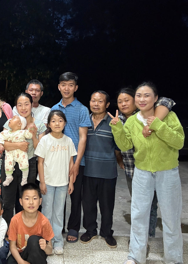 all villagers posing together outdoors at night